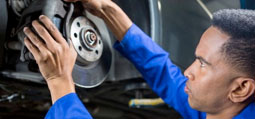 Auto Technician at Capital Performance in Atlanta fixing brakes